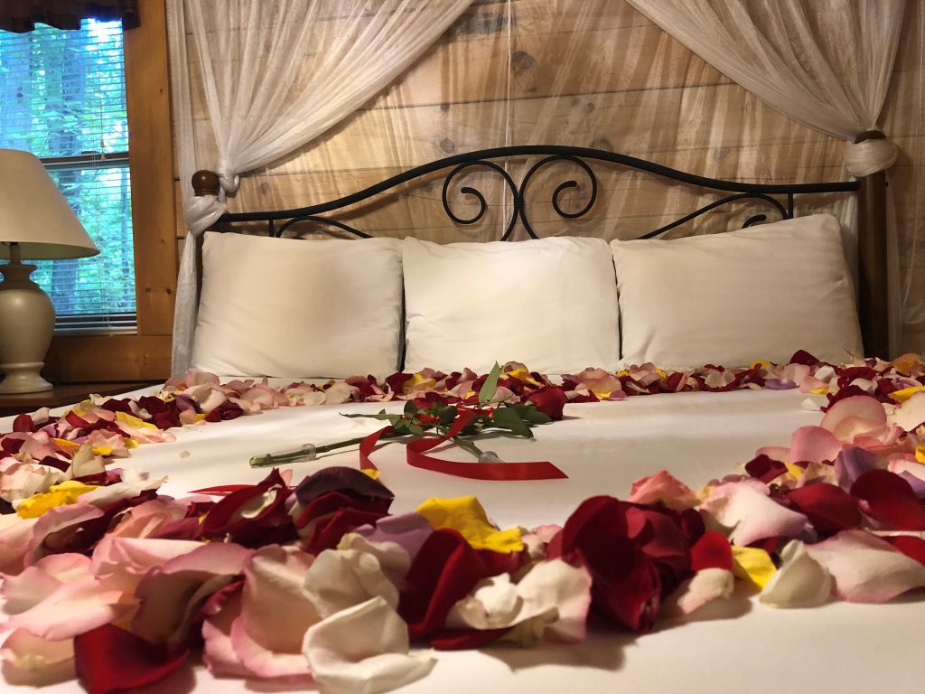 Hideaway Cabin King Bedroom with Flower Petals on Bed