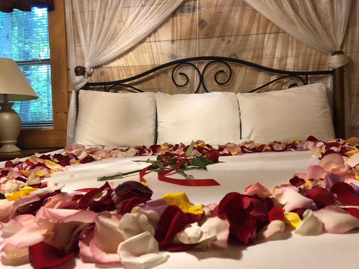 Hideaway Cabin King Bedroom with Flower Petals on Bed