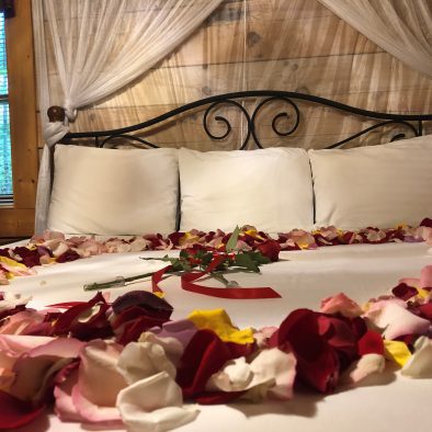 Hideaway Cabin King Bedroom with Flower Petals on Bed