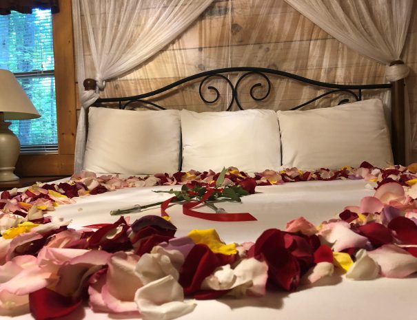 Hideaway Cabin King Bedroom with Flower Petals on Bed